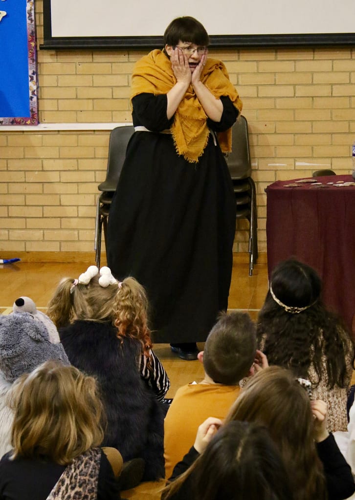 Lynda performing the story of the Amesbury Archer for storytelling at a school