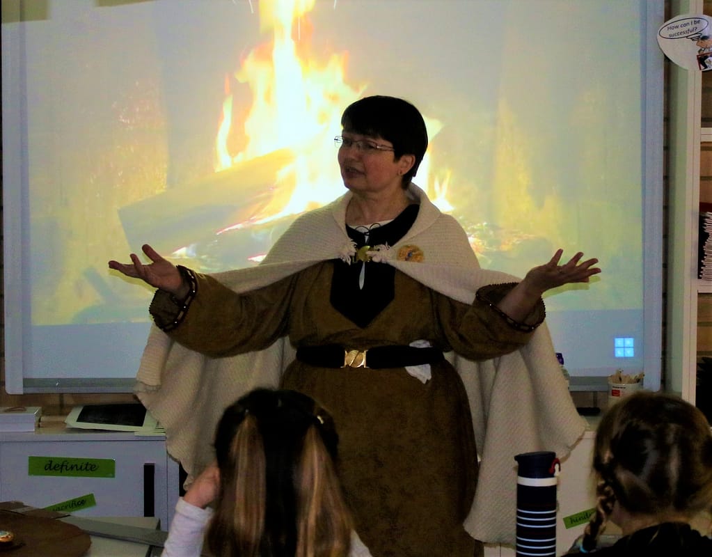 Lynda performing Beowulf for storytelling at a school