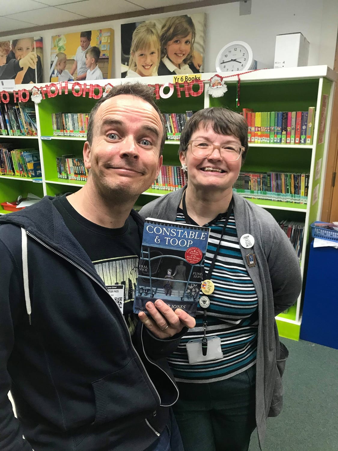 Lynda with Gareth P Jones on a school visit, holding a copy of Constable & Toop